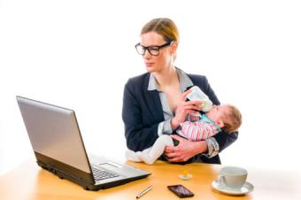 businesswoman feeding her baby