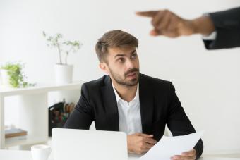 Worker at desk getting fired