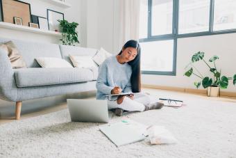 Young woman writing down something
