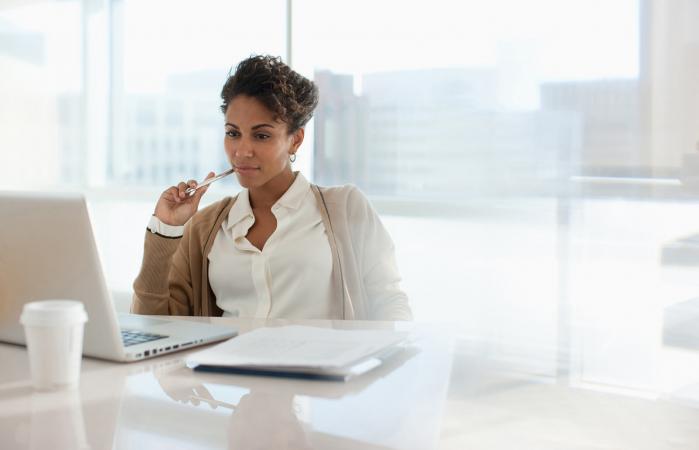 Businesswoman reading manger job description online