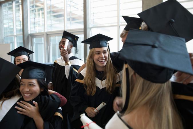 Graduates in caps and gowns celebrating