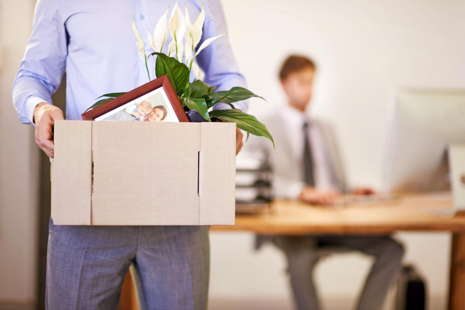 Man leaving with a box of his possessions after being fired