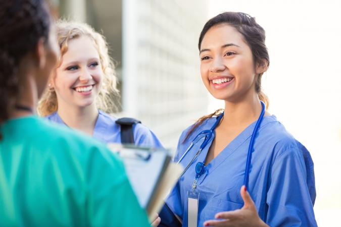 Nursing students talking together on college campus