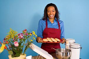 Woman presenting plate of cookies