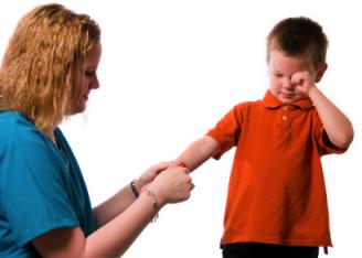 Nurse treating little boy