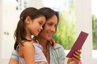 Mother and daughter looking at card