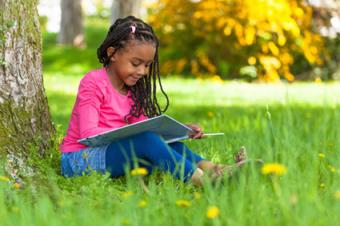 Girl listening to and reading book