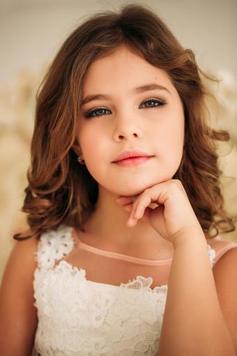 Kid Fashion, Style. Girl Model Pose In Jeans Overall Full Length. Beauty,  Look Concept. Child With Long Healthy Brunette Hair On Blue Background.  Youth, Skincare, Health. Stock Photo, Picture and Royalty Free