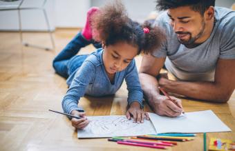 Father and daughter coloring together