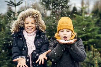 Brother and sister having fun with snow