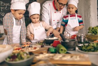 Father teaching kids to cook