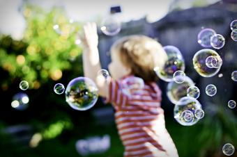 Boy chasing bubbles