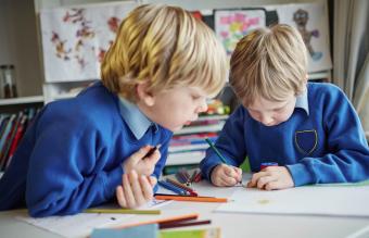 Two school children working together