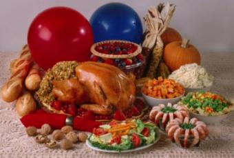 A Thanksgiving dinner with turkey, vegetables, bread, and pie