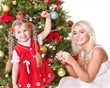 Mother and daughter by Christmas tree