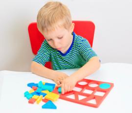 Little boy with shape puzzle