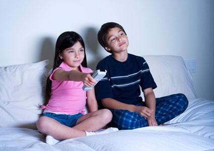 two kids watching television