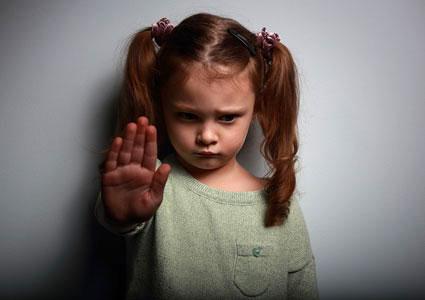 Girl signaling to stop violence