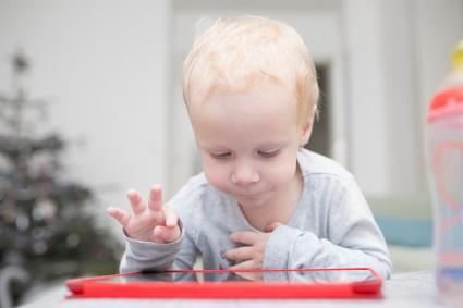 toddler with tablet