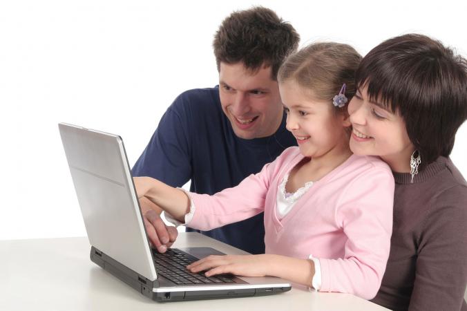 Parents and daughter using laptop