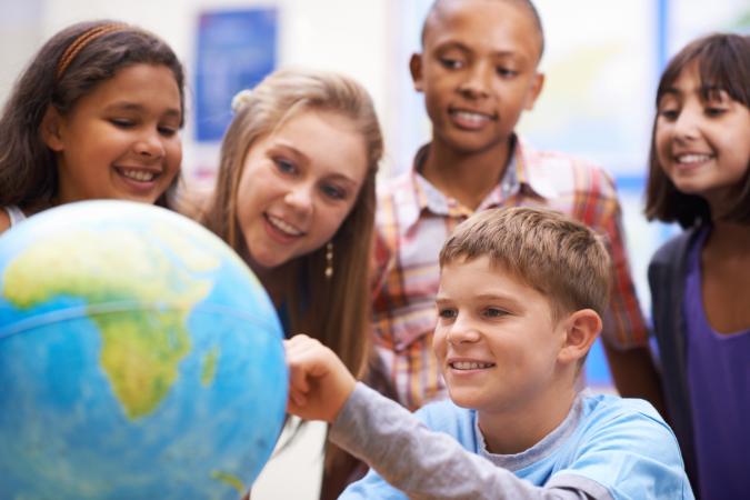 Kids looking at a globe