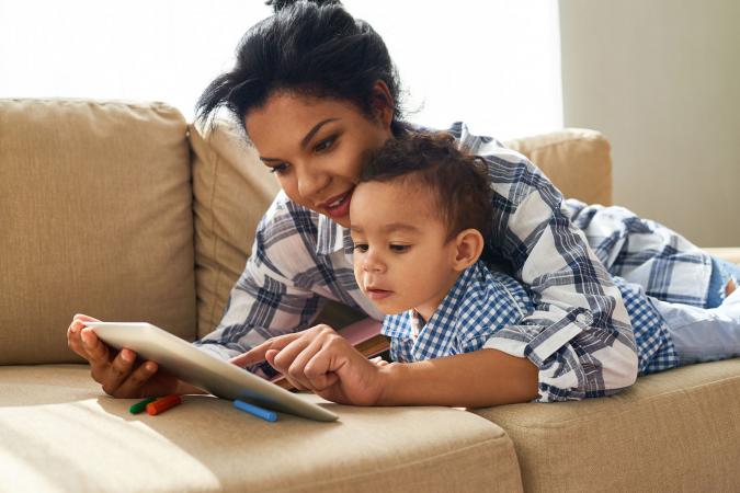 Mom showing son website on tablet