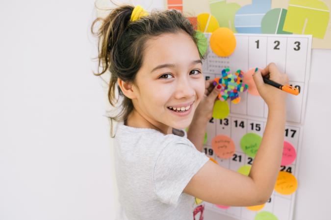 Child writing on calendar