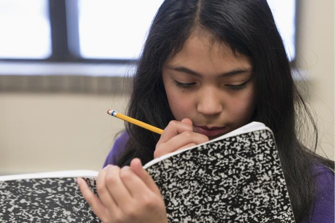 girl writing in journal