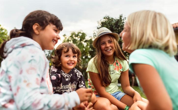 Four girls talking and telling jokes