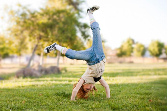 girl doing cartwheel outside
