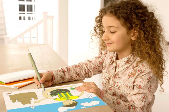 Girl coloring beach page at table