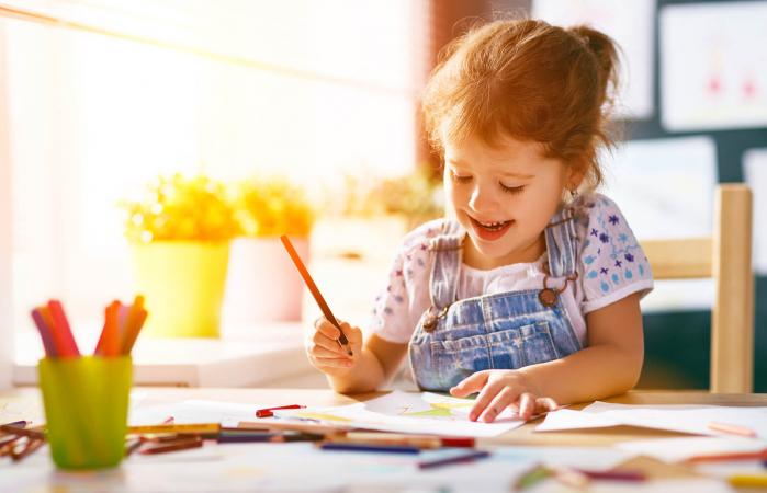 Girl coloring fire engine drawing