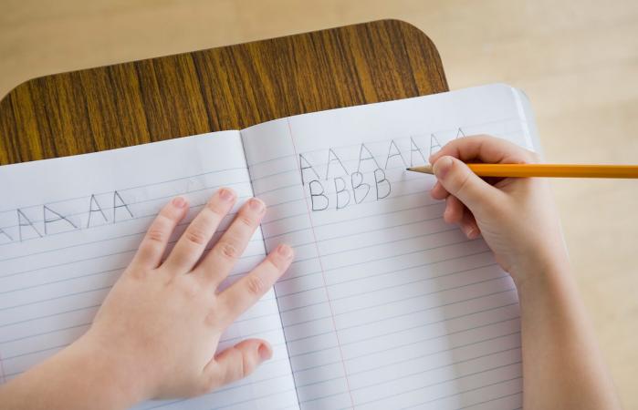 Boy writing letters