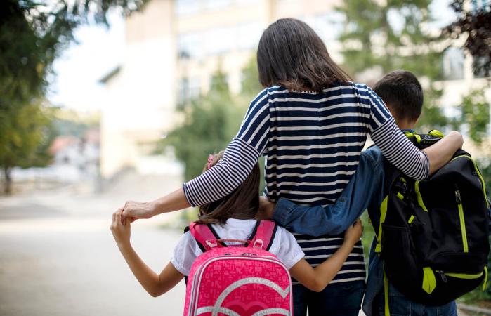 Mother taking kids to school