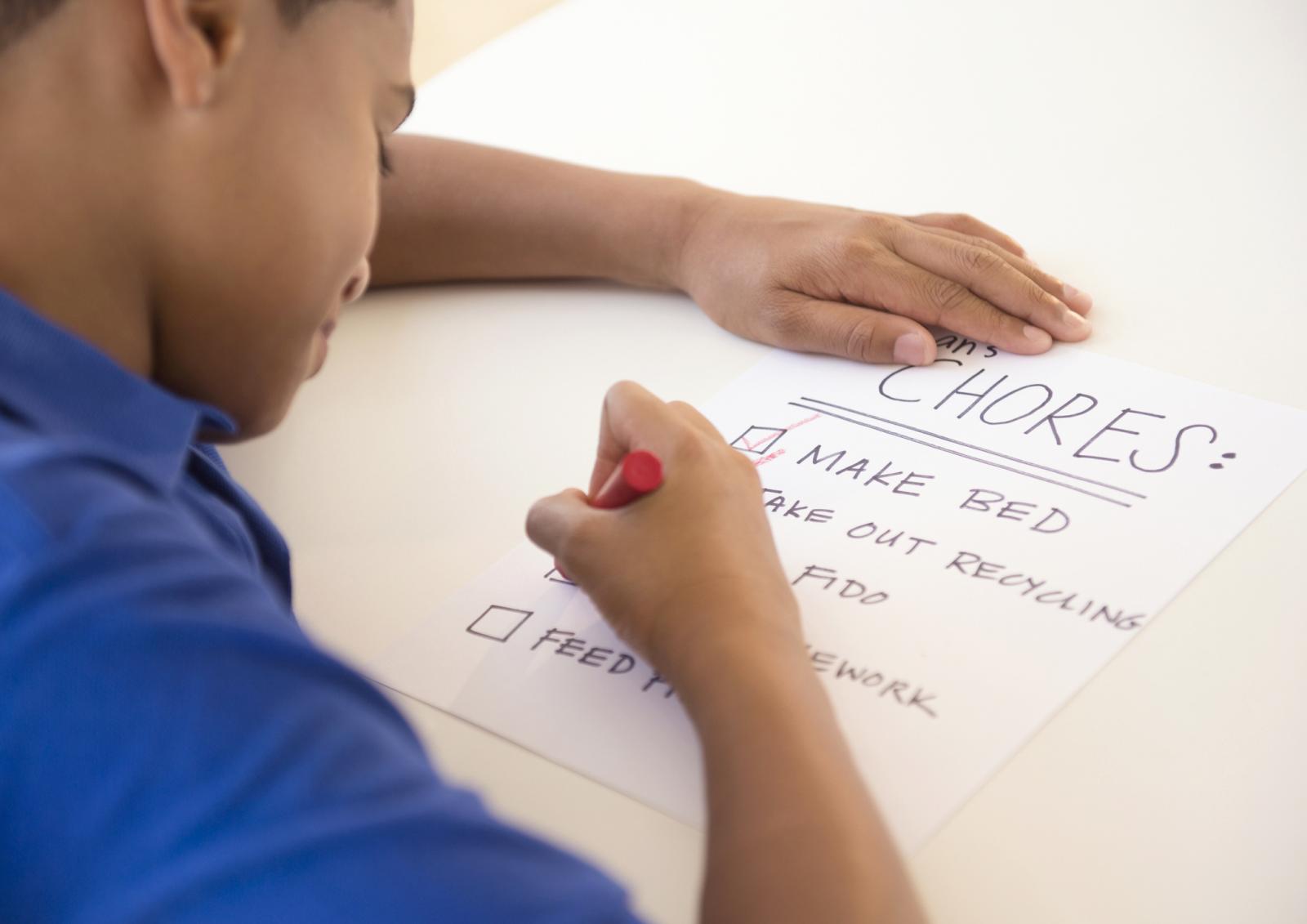 Boy checking off chore list
