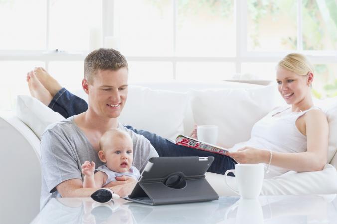 family relaxing together reading magazine