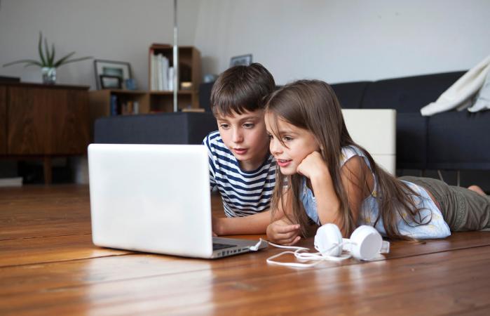 Siblings using laptop