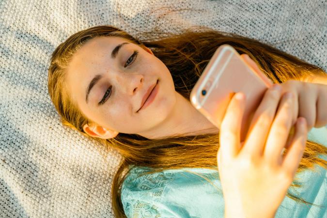 Girl reading text on cell phone
