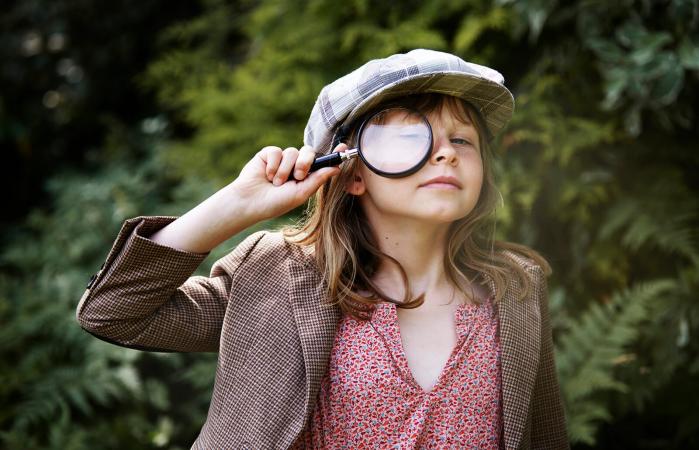 little girl with magnifying glass