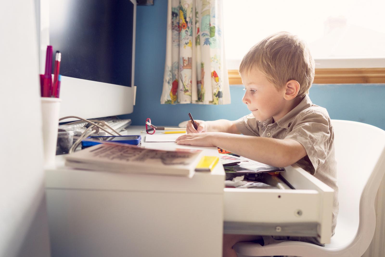 Young boy drawing at home