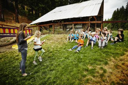 Kids at Bible camp reading outside