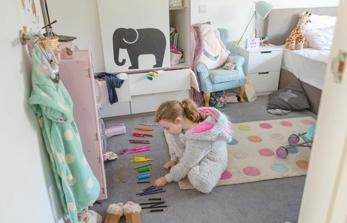 Girl playing in her bedroom