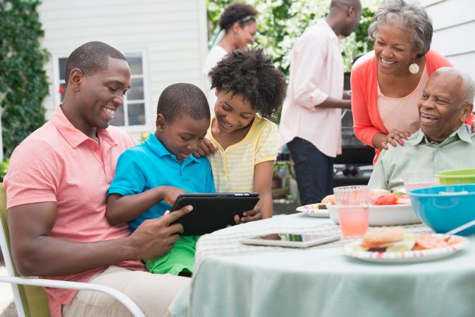 family looking at photos at bbq
