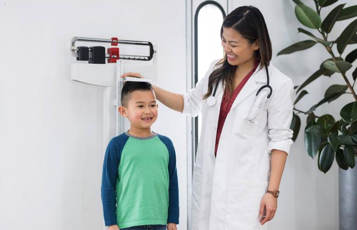 Boy getting their height measured