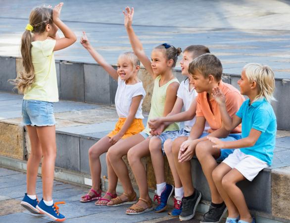 Cheerful boys and girls playing charades