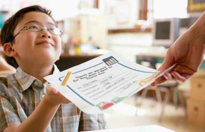 Student giving a note to a teacher