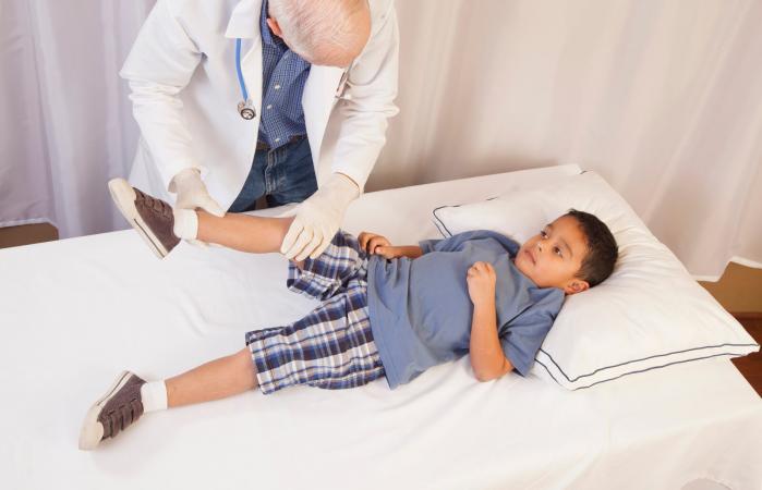 boy in doctor's office on exam table