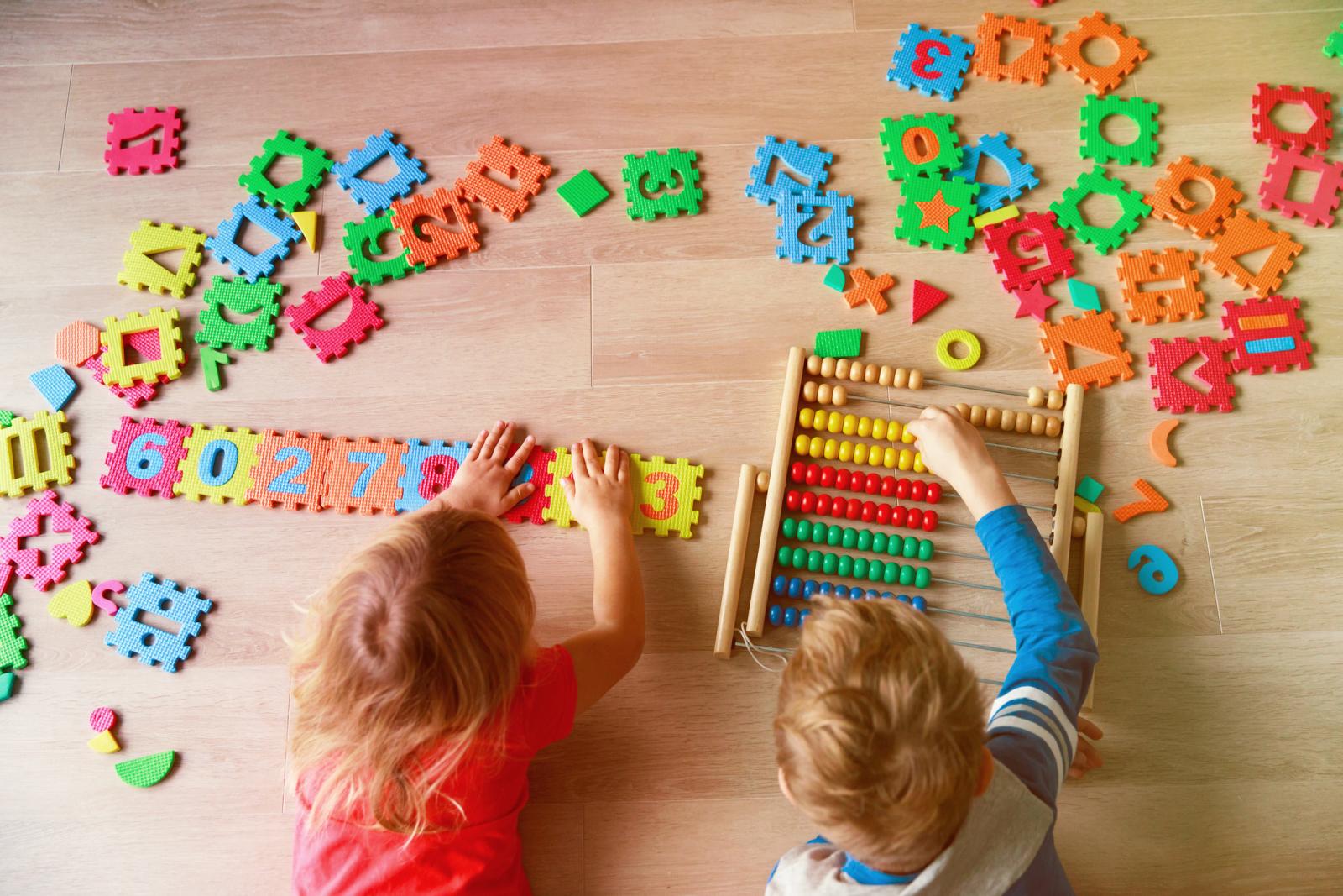 Little boy and girl learn to calculate numbers