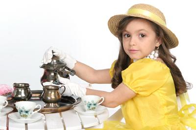 Image of a little girl having a tea party