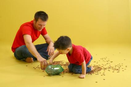 Kindergartener and dad counting pennies